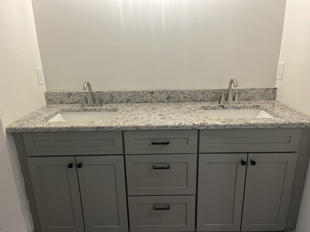 Gray shaker double vanity with white granite top, bathroom remodel by Middletown Bath Co.