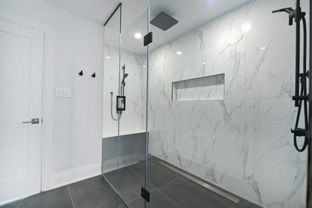 Frameless glass shower door in a remodeled bathroom
