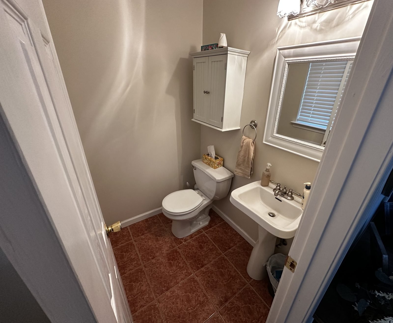 Small bathroom before remodel with red tile floor and pedestal sink, Middletown NY